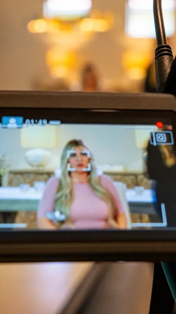 Camera monitor framing a guest in pink