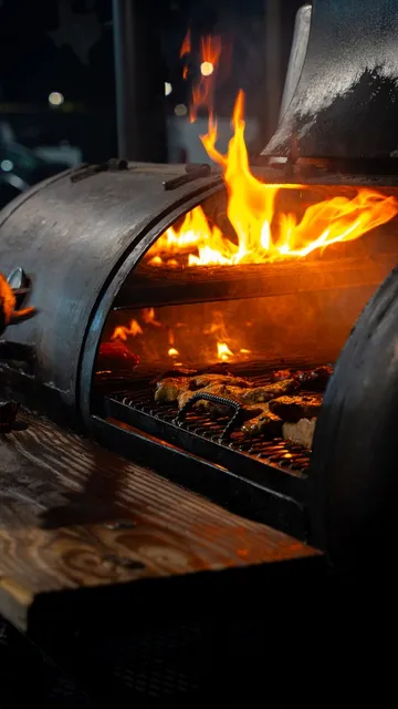 Meat cooking over an open fire grill